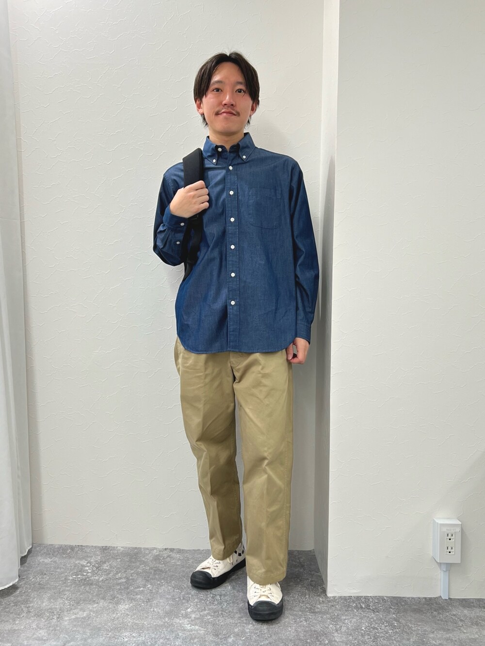 ブルー系のシャツ/ブラウス、ブラック系のバックパック/リュックを着用したメンズの春コーディネートの2枚目の写真