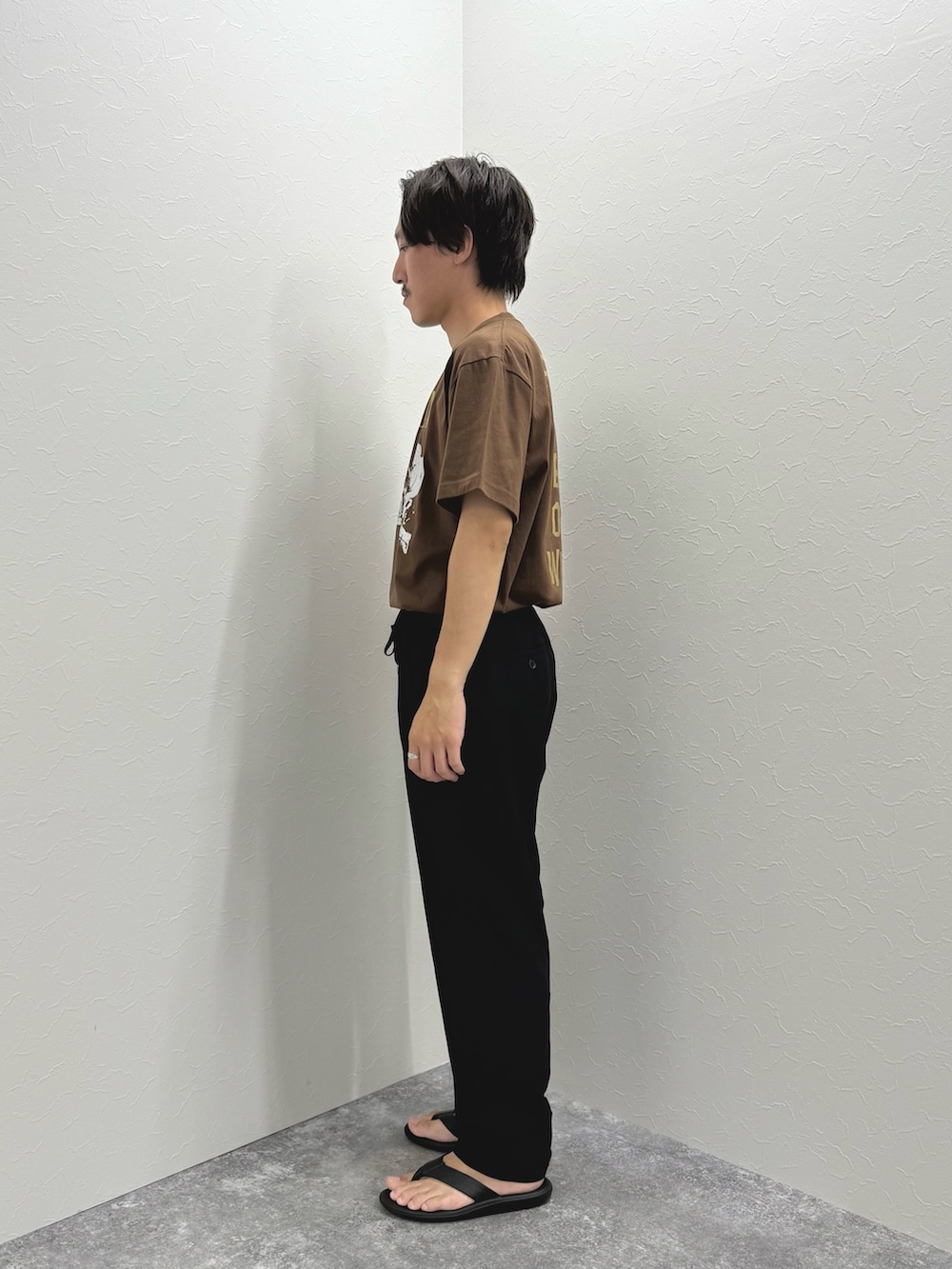 ブラウン系のTシャツ/カットソー、ブラック系のその他パンツ、ブラック系のサンダルを着用したメンズの夏コーディネートの4枚目の写真