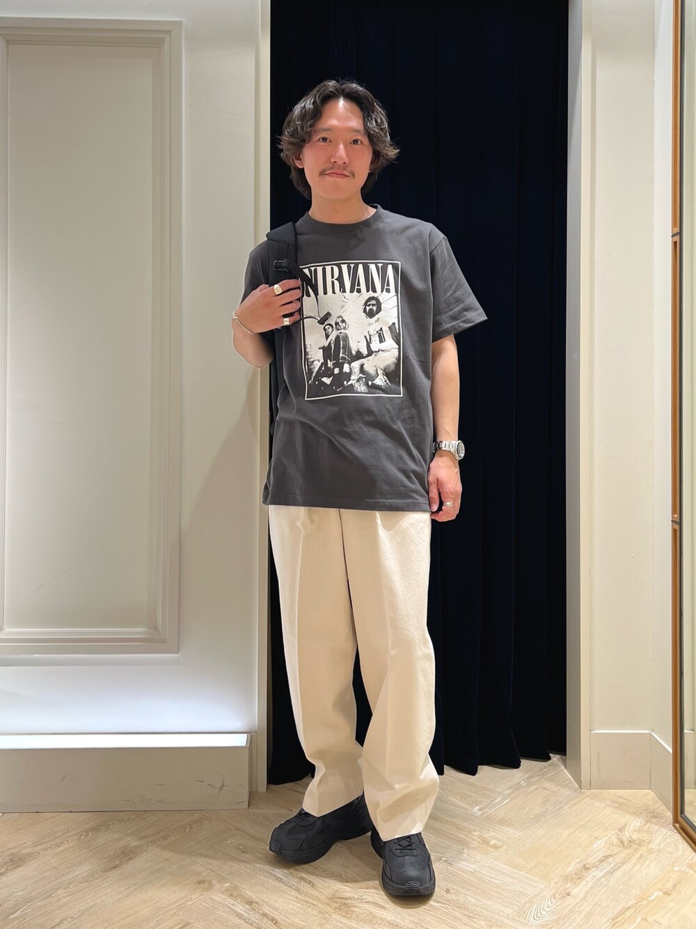 ブラック系のTシャツ/カットソー、ブラック系のバックパック/リュック、ブラック系のスニーカーを着用したメンズの春コーディネートの3枚目の写真