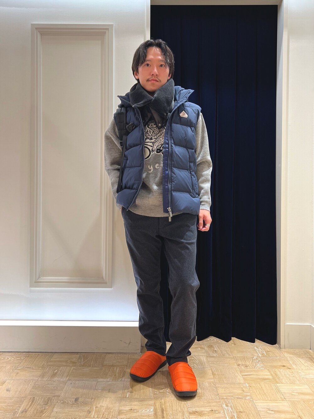 グレー系のニット/セーター、ブルー系のその他パンツ、オレンジ系のサンダルを着用したメンズの冬コーディネートの3枚目の写真