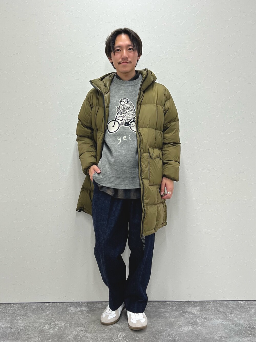 グリーン系のダウンジャケット/コート、グレー系のニット/セーター、グリーン系のシャツ/ブラウスを着用したメンズの冬コーディネートの5枚目の写真