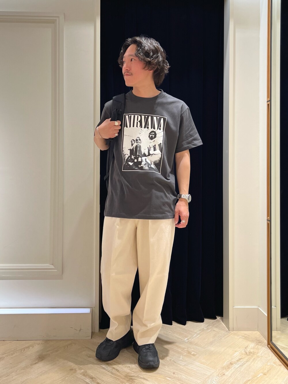 ブラック系のTシャツ/カットソー、ブラック系のバックパック/リュック、ブラック系のスニーカーを着用したメンズの春コーディネートの4枚目の写真