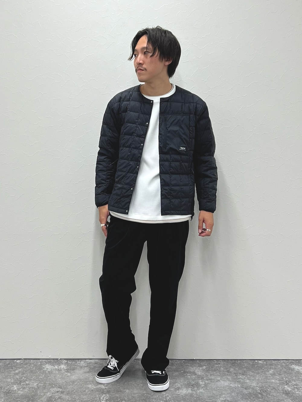 ブラック系のダウンジャケット/コート、ホワイト系のTシャツ/カットソーを着用したメンズの秋コーディネートの3枚目の写真