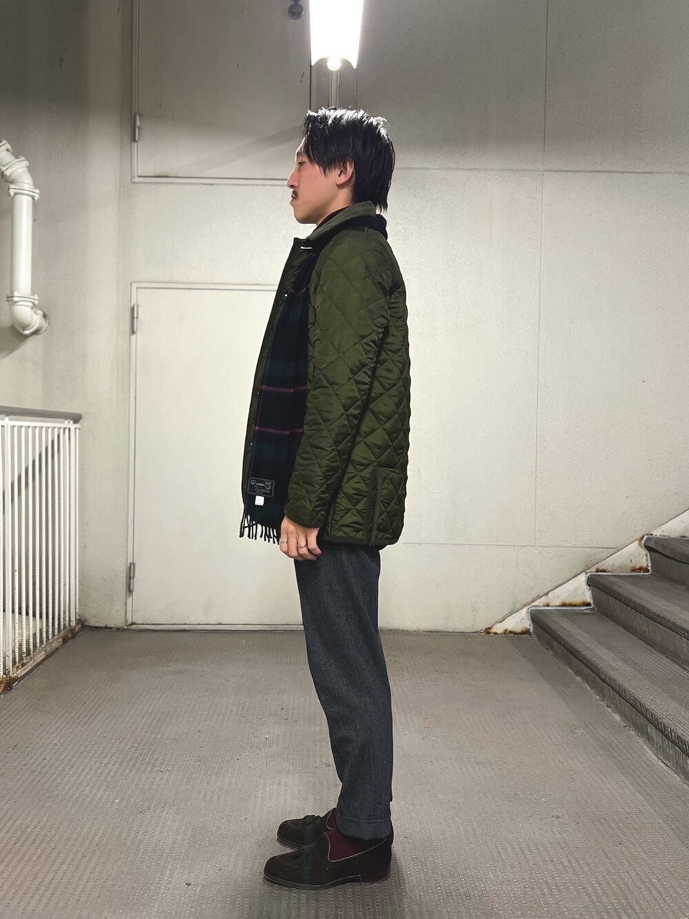 グリーン系のブルゾン、グリーン系のマフラーを着用したメンズの冬コーディネートの3枚目の写真