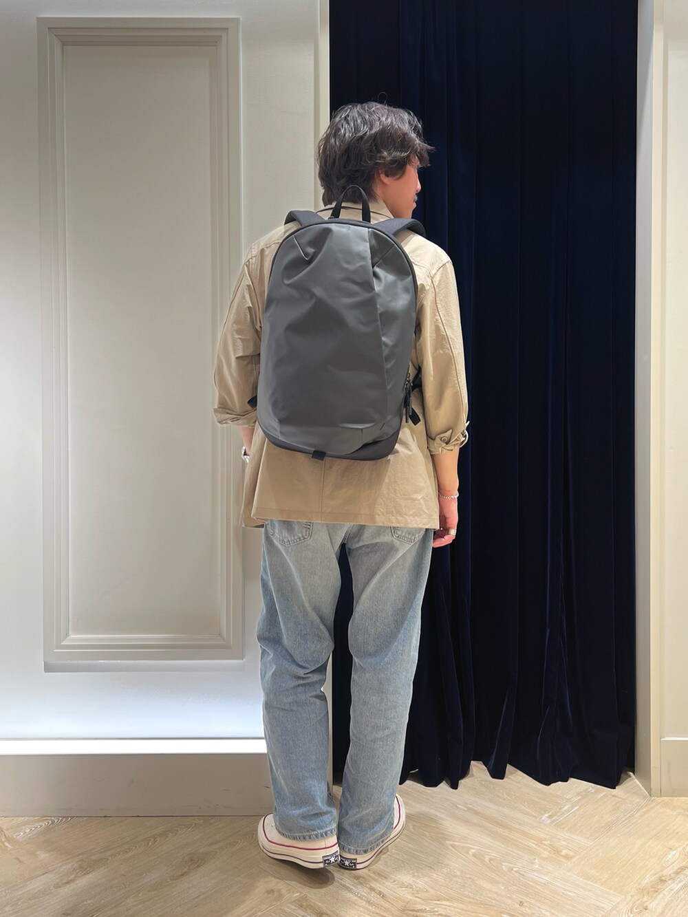 ベージュ系のミリタリージャケット、ブラック系のTシャツ/カットソー、ブラック系のバックパック/リュックを着用したメンズの春コーディネートの4枚目の写真