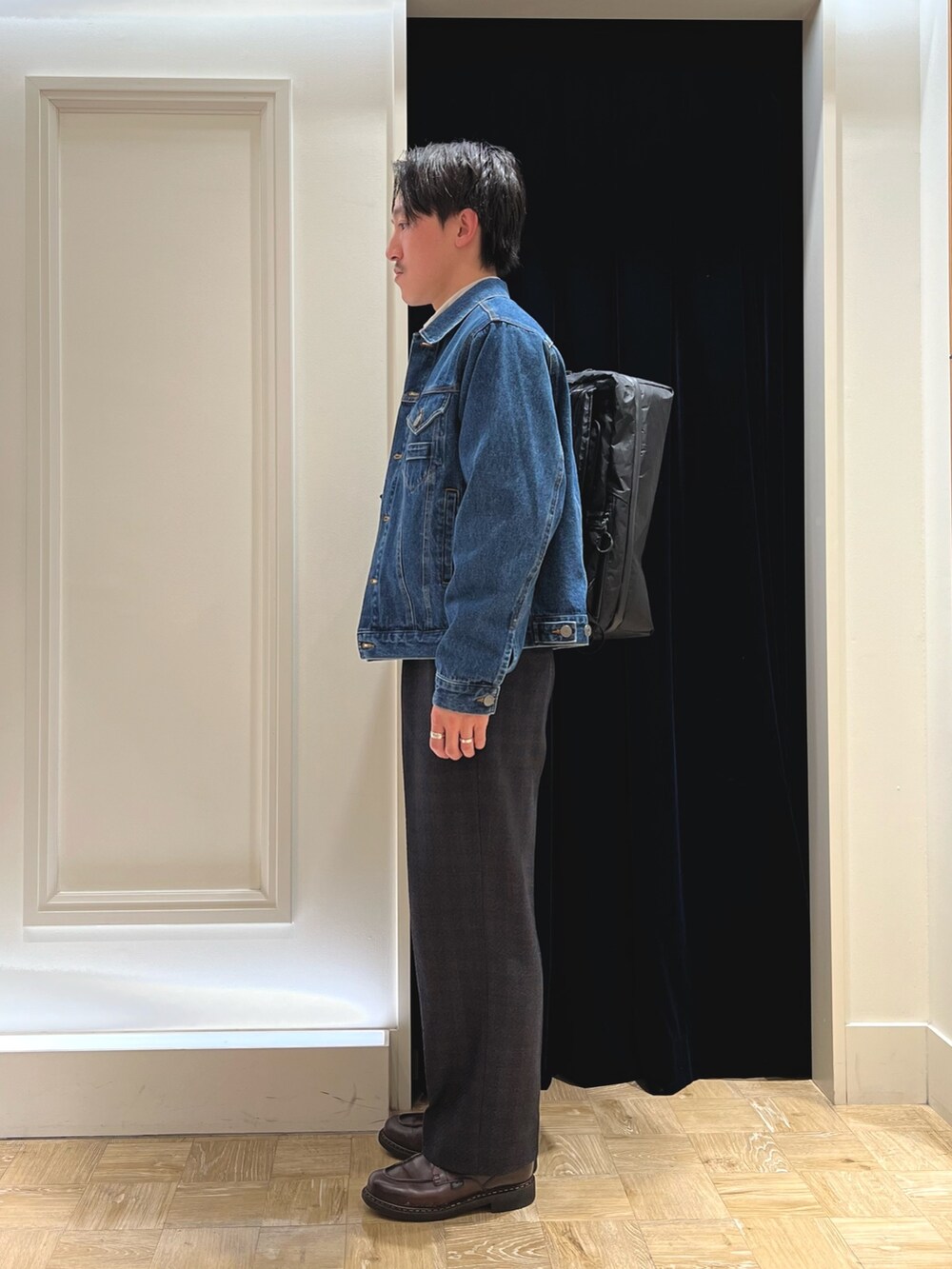 ブルー系のデニムジャケット、ベージュ系のシャツ/ブラウス、ブラック系のバックパック/リュックを着用したメンズの冬コーディネートの4枚目の写真