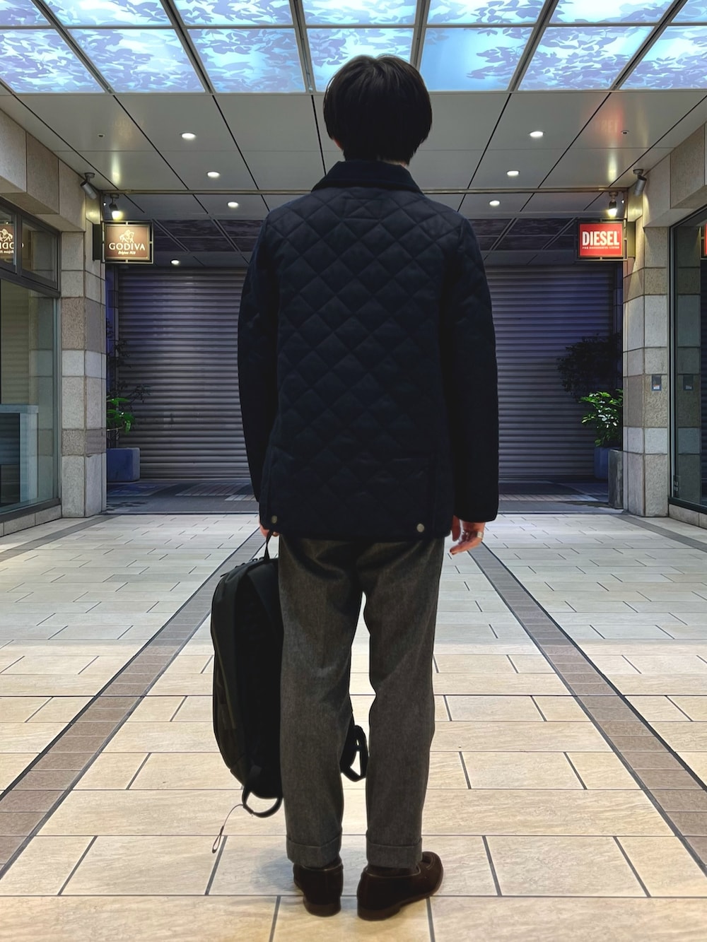 ブルー系のテーラードジャケット、ホワイト系のニット/セーター、ブラウン系のローファーを着用したメンズの冬コーディネートの5枚目の写真