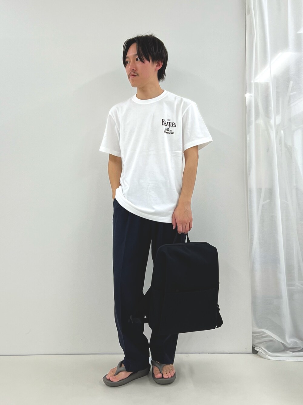 ホワイト系のTシャツ/カットソー、ブラック系のその他パンツ、ブラック系のバックパック/リュックを着用したメンズの春コーディネートの2枚目の写真