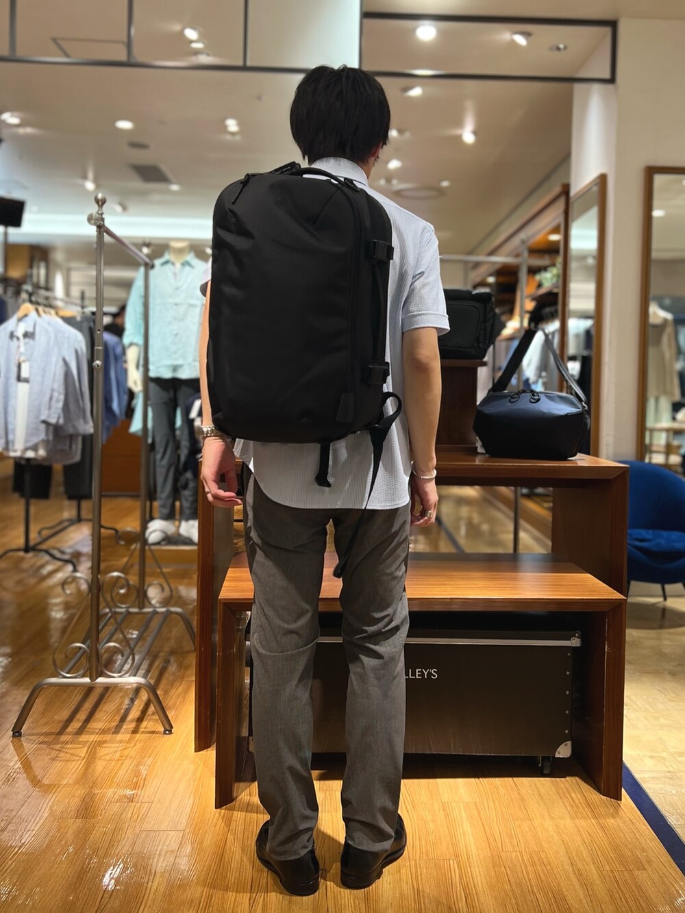 ホワイト系のシャツ/ブラウス、ブラック系のバックパック/リュック、ブルー系のその他パンツを着用したメンズの夏コーディネートの6枚目の写真