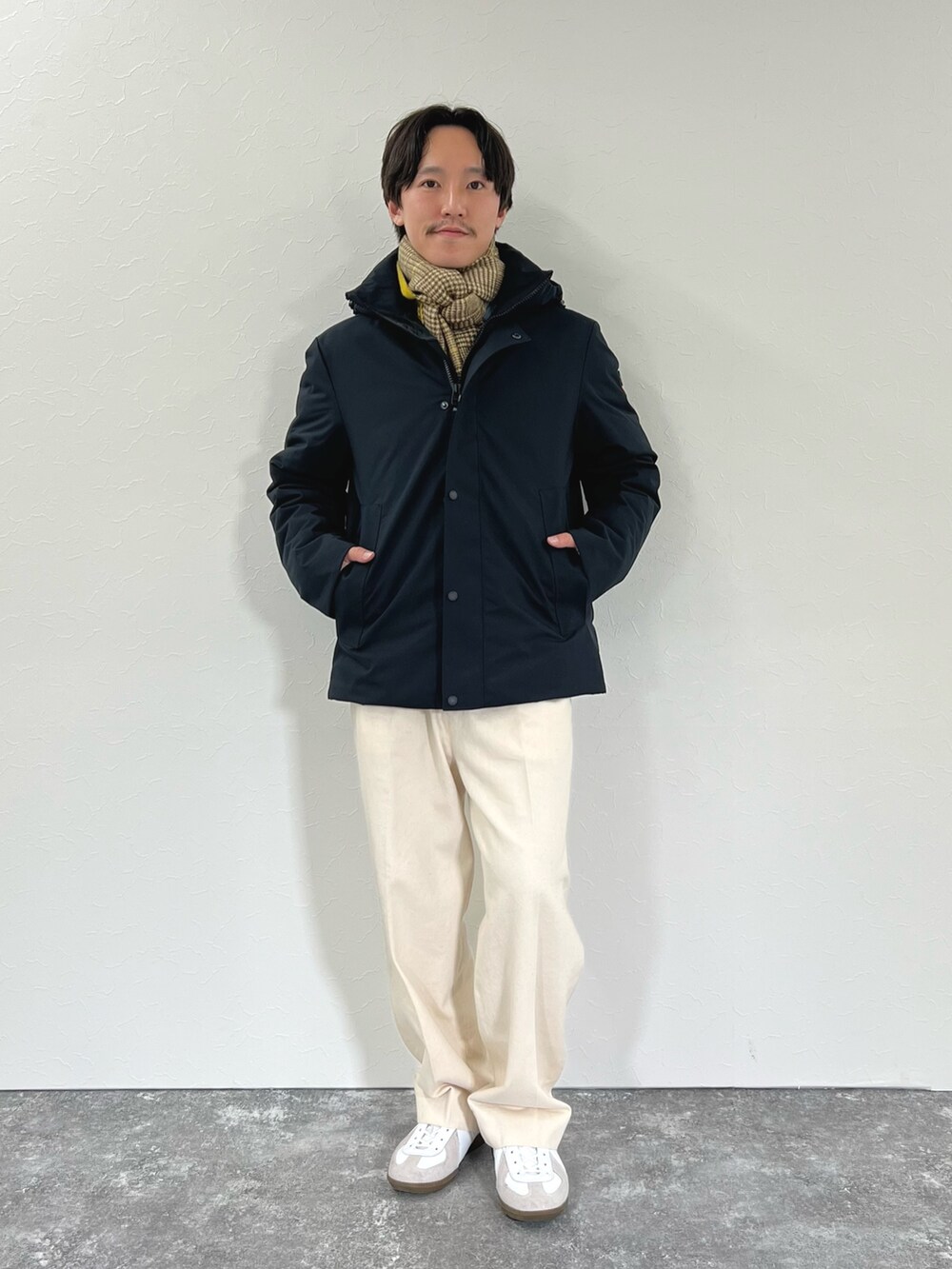 ブラック系のダウンジャケット/コート、ブルー系のシャツ/ブラウス、イエロー系のマフラーを着用したメンズの冬コーディネートの6枚目の写真