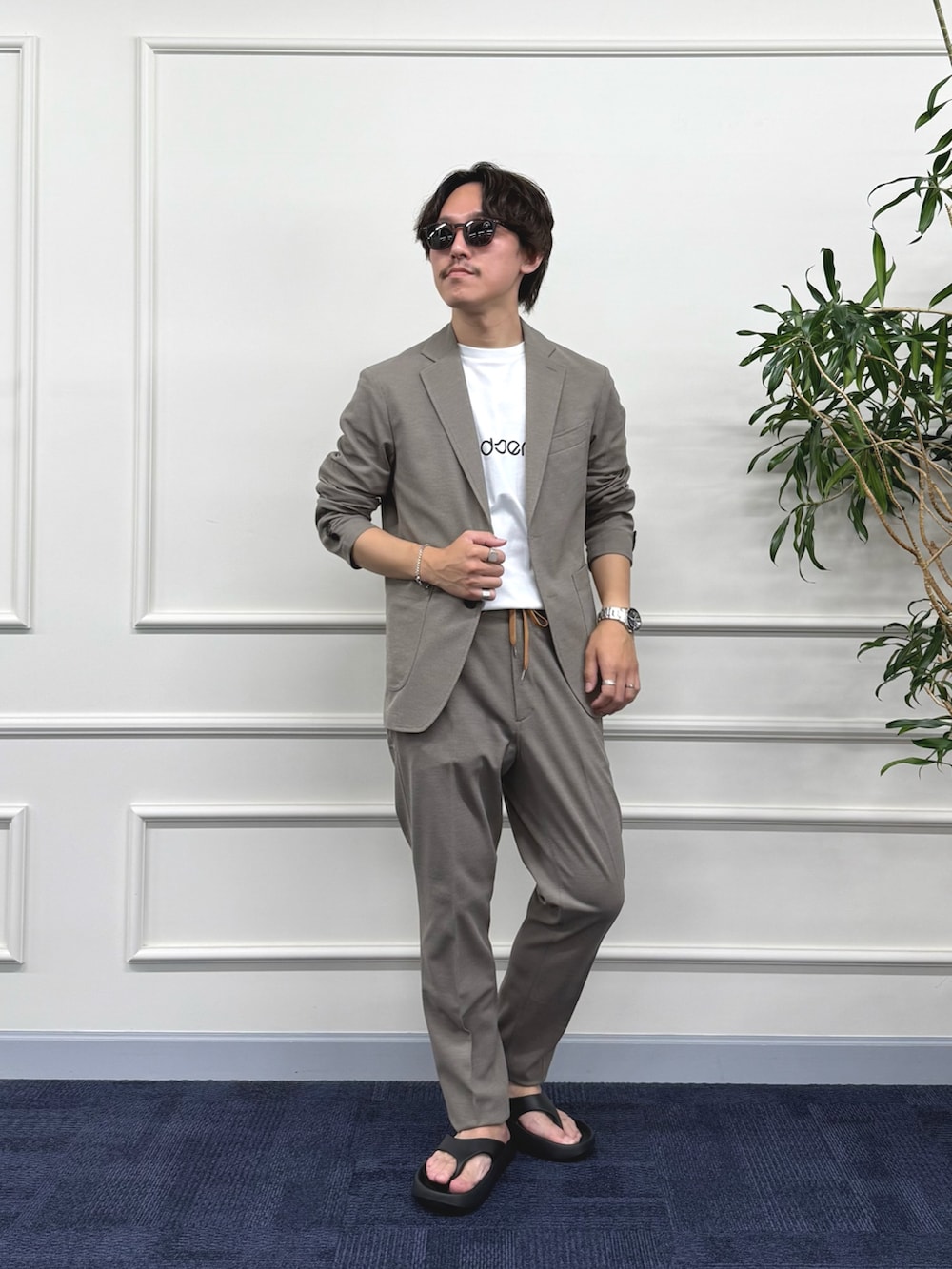 ベージュ系のテーラードジャケット、ベージュ系のその他パンツ、ホワイト系のTシャツ/カットソーを着用したメンズの夏コーディネートの2枚目の写真