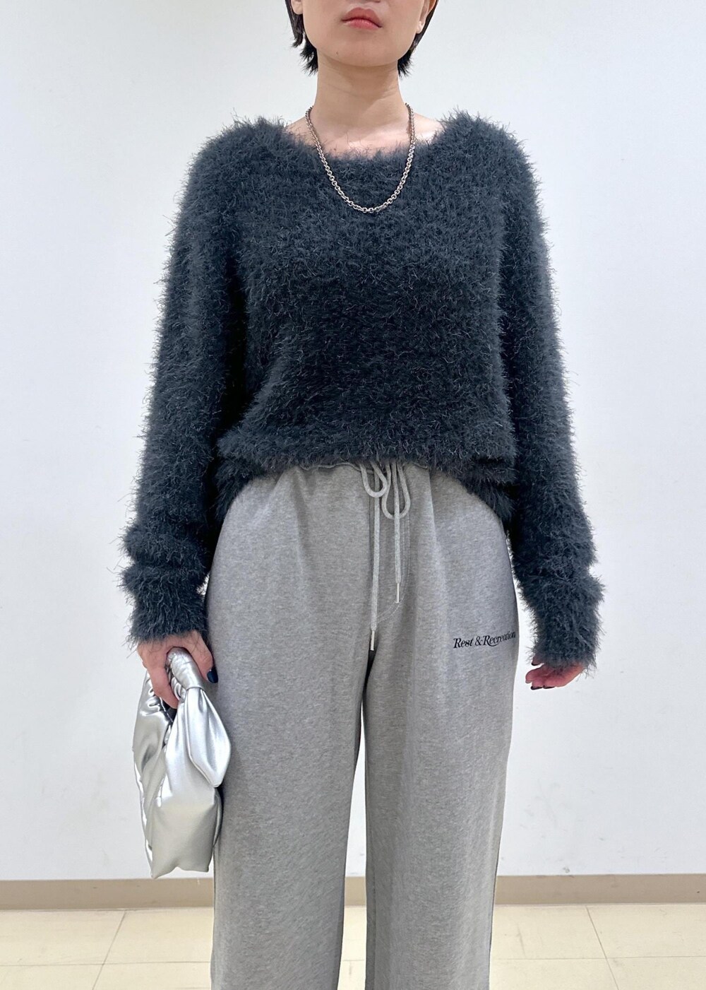 ホワイト系のパンプス、グレー系のニット/セーター、シルバー系のショルダーバッグを着用したレディースの秋コーディネートの7枚目の写真