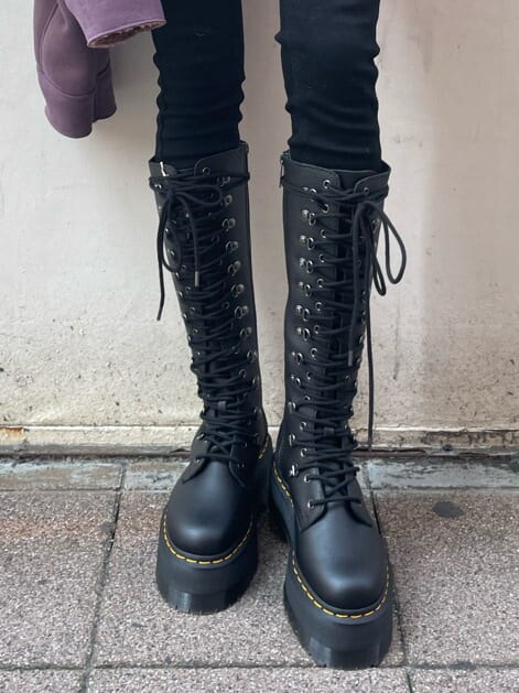 ブラック系のブーツ、パープル系のブルゾン、ブラック系のショルダーバッグを着用したレディースの冬コーディネートの6枚目の写真