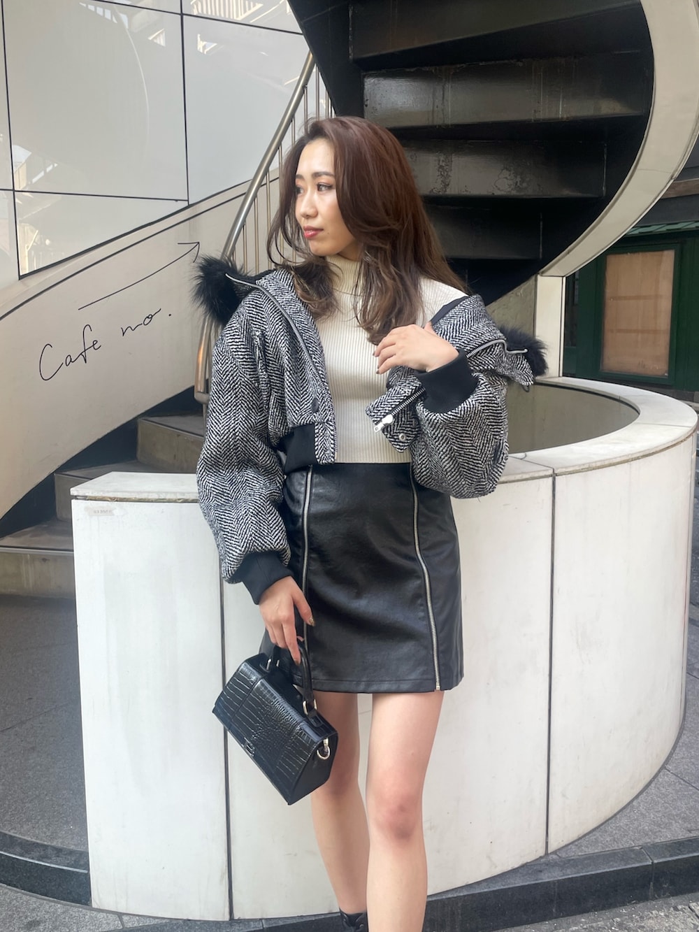 ブラック系のショルダーバッグ、ブラック系のブーツ、ブラック系のスカートを着用したレディースの秋コーディネートの3枚目の写真