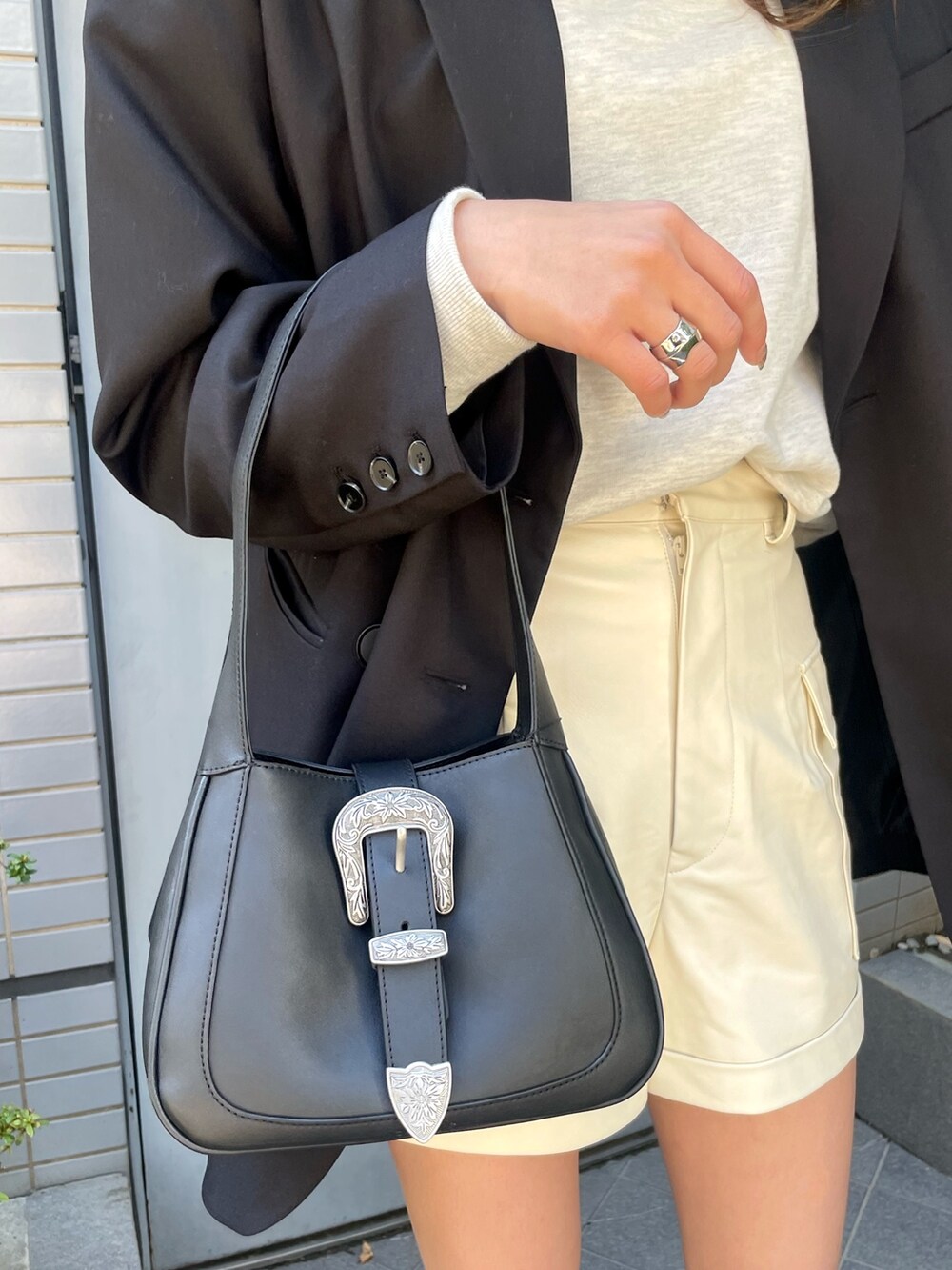 ブラック系のテーラードジャケット、グレー系のスウェット、ホワイト系のその他パンツを着用したレディースの冬コーディネートの5枚目の写真