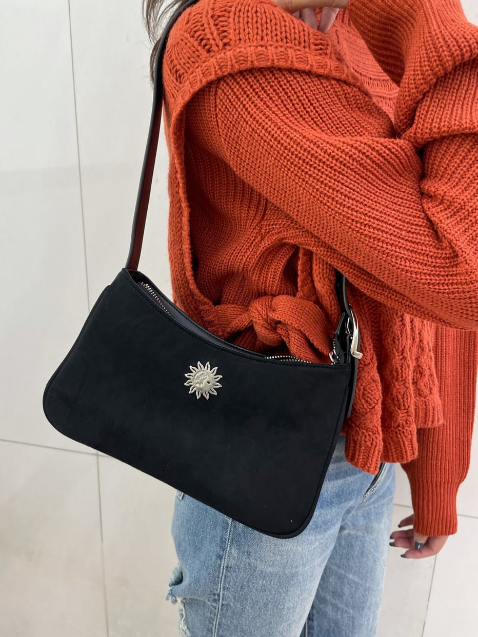 ブルー系のデニムパンツ、ブラック系のショルダーバッグ、オレンジ系のニット/セーターを着用したレディースの秋コーディネートの6枚目の写真