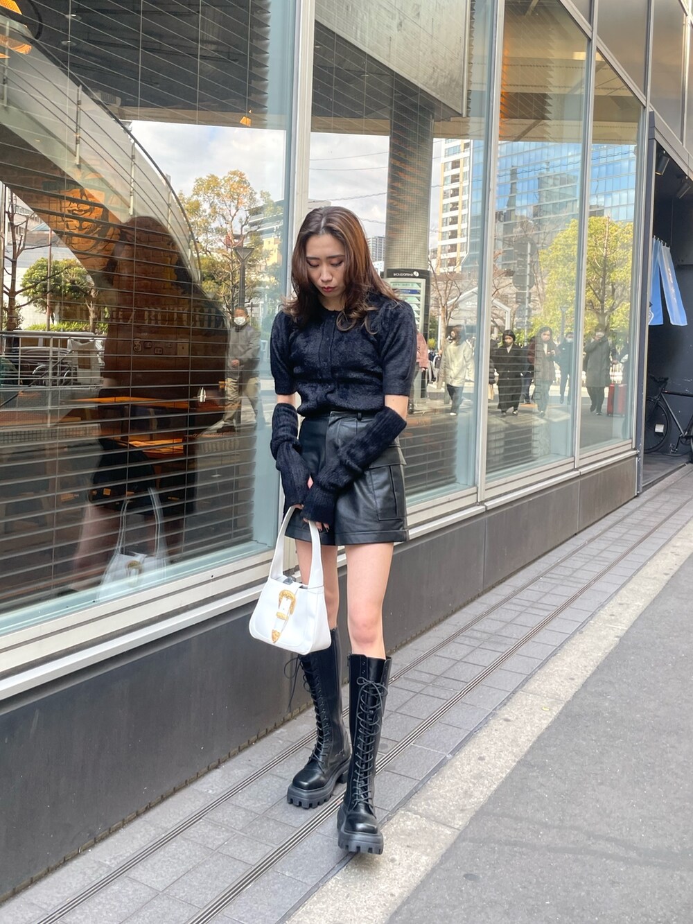 ブラック系のニット/セーター、ブラック系のその他パンツ、ホワイト系のハンドバッグを着用したレディースの冬コーディネートの8枚目の写真