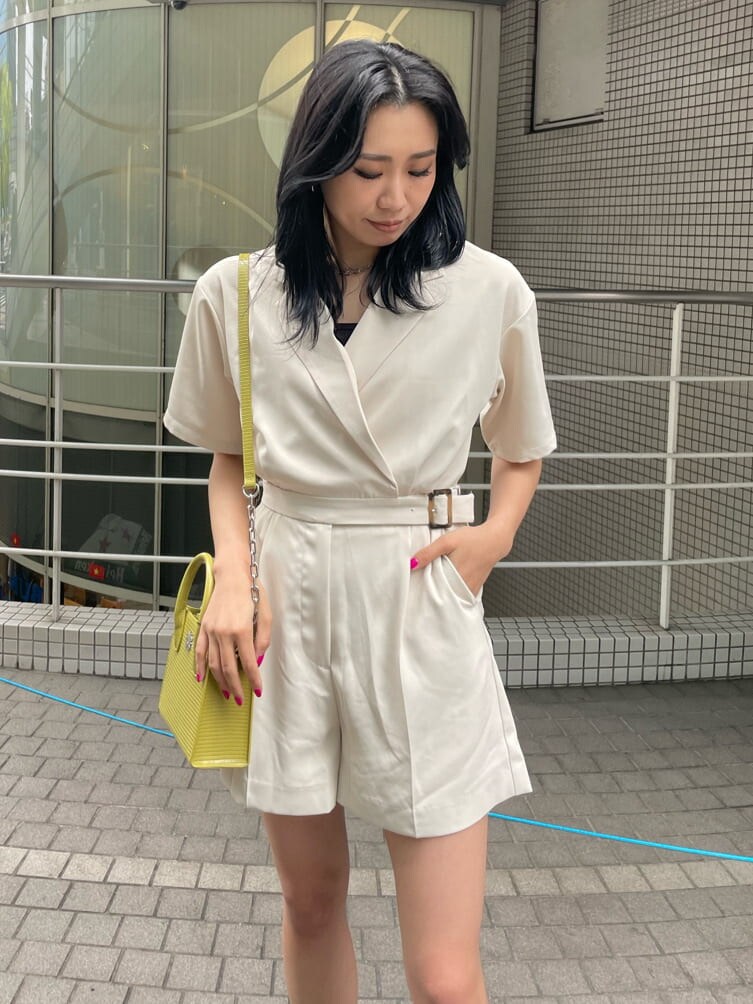 ホワイト系のつなぎ/オールインワン、ブラック系のブーツ、イエロー系のショルダーバッグを着用したレディースの春コーディネートの3枚目の写真