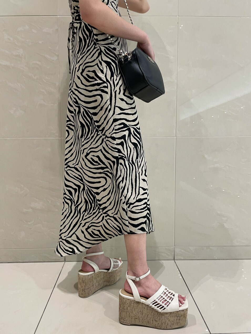 ホワイト系のTシャツ/カットソー、ホワイト系のサンダル、シルバー系のネックレスを着用したレディースの春コーディネートの8枚目の写真