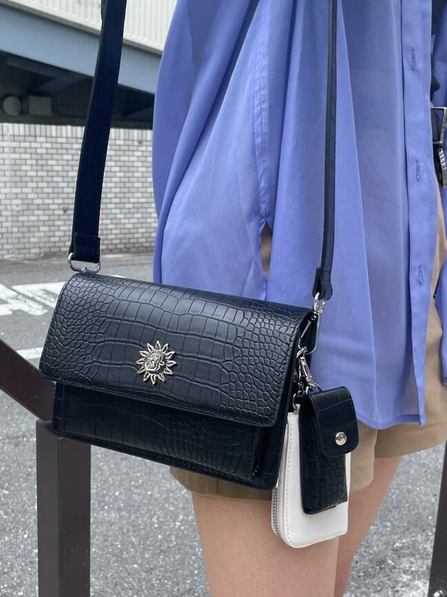 ブルー系のシャツ/ブラウス、ベージュ系のその他パンツ、ブラック系のショルダーバッグを着用したレディースの春コーディネートの8枚目の写真