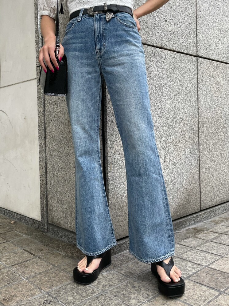 ブラック系のキャミソール、ホワイト系のシャツ/ブラウス、ブルー系のデニムパンツを着用したレディースの春コーディネートの6枚目の写真