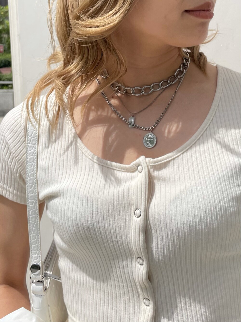 ホワイト系のシャツ/ブラウス、ブラック系のサンダル、シルバー系のネックレスを着用したレディースの春コーディネートの5枚目の写真