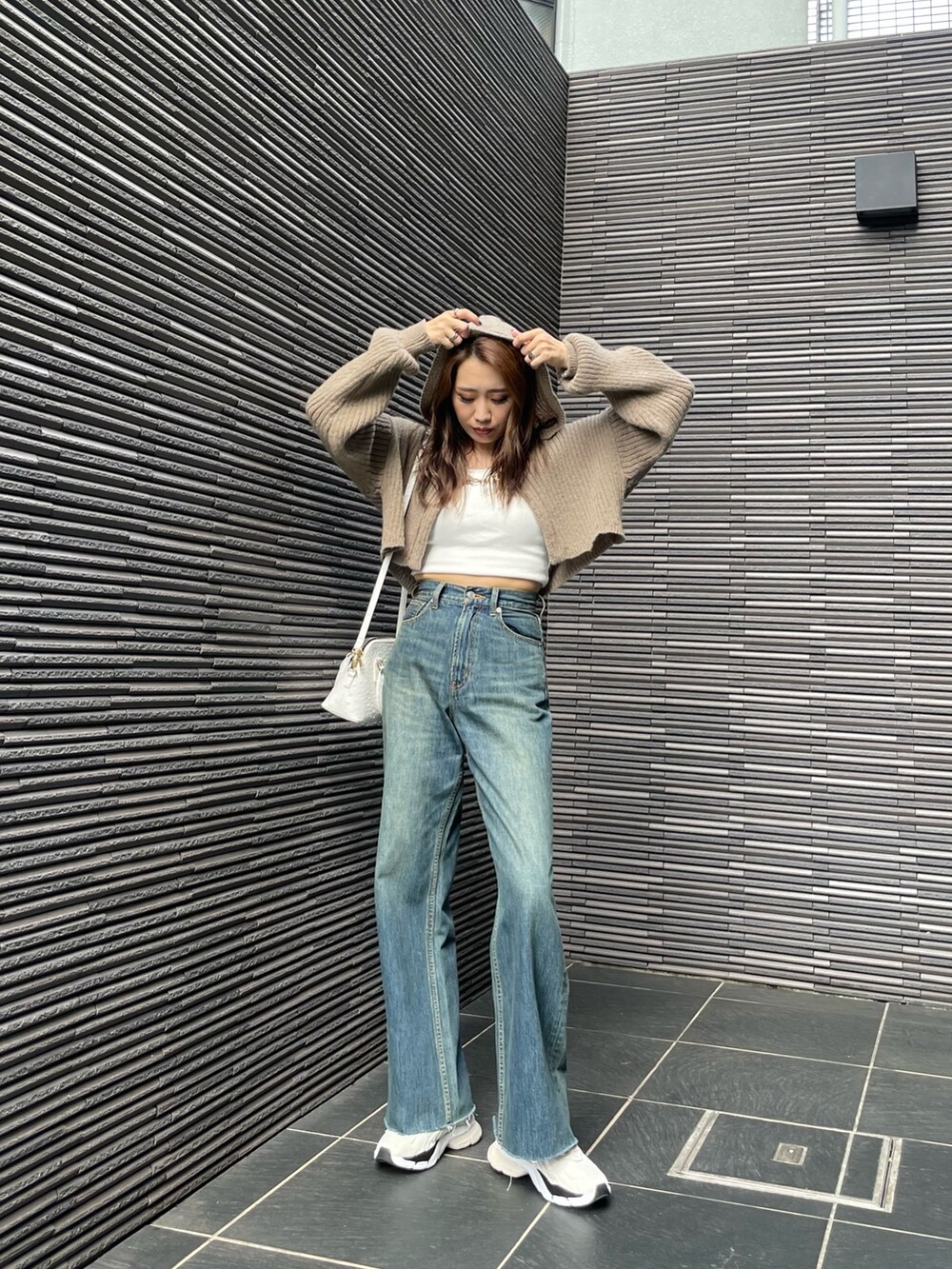 ホワイト系のスニーカー、ホワイト系のキャミソール、ベージュ系のカーディガン/ボレロを着用したレディースの夏コーディネートの2枚目の写真