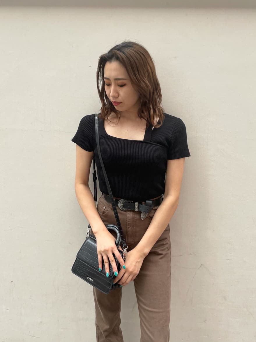 ブラウン系のデニムパンツ、ブラック系のサンダル、ブラック系のニット/セーターを着用したレディースの秋コーディネートの3枚目の写真