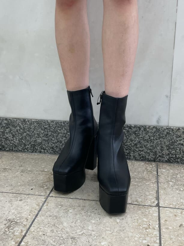 ベージュ系のニット/セーター、ブラック系のブーツ、ブラック系のショルダーバッグを着用したレディースの秋コーディネートの5枚目の写真