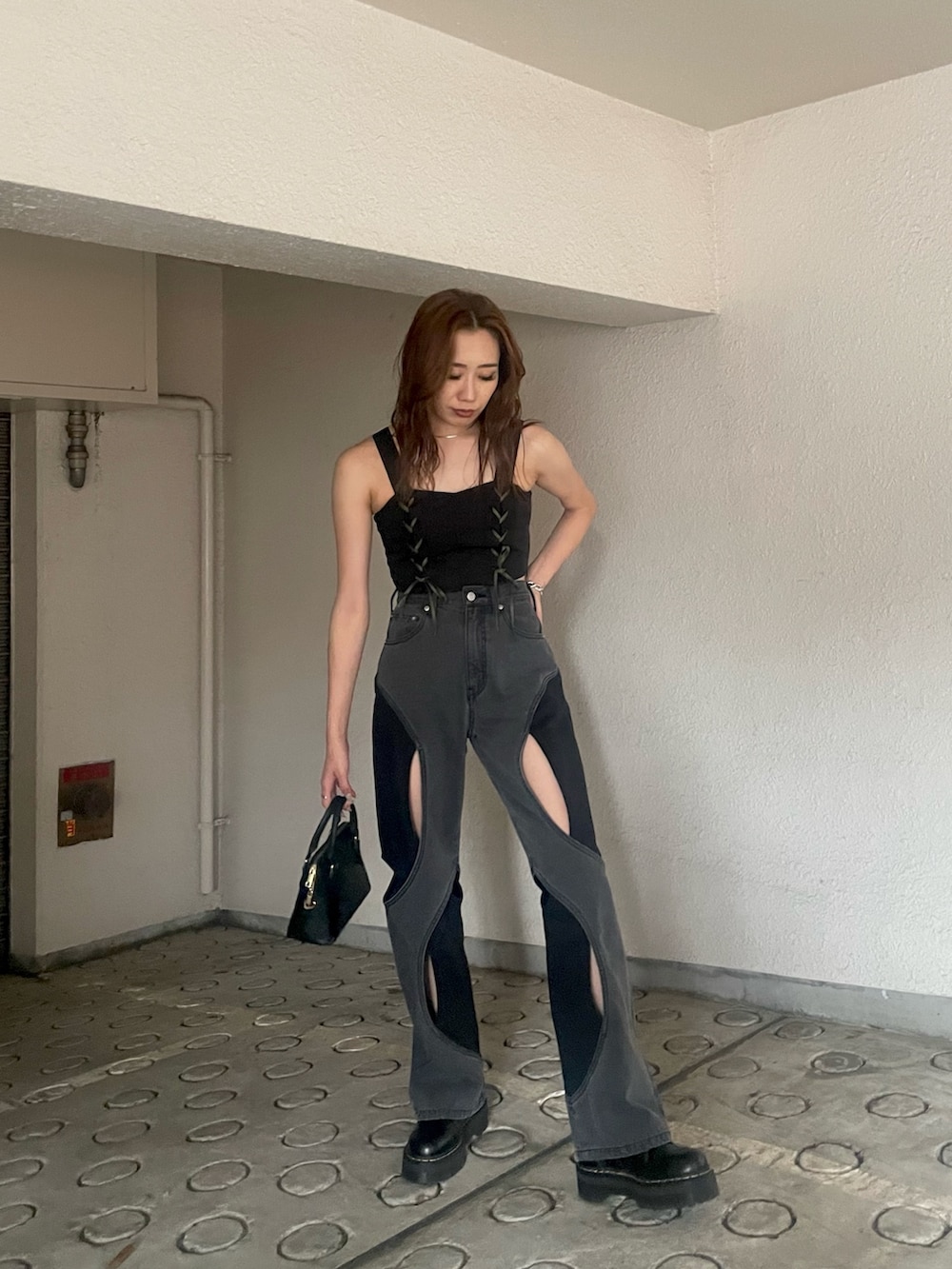 ブラック系のキャミソール、ブラック系のデニムパンツを着用したレディースの夏コーディネートの2枚目の写真