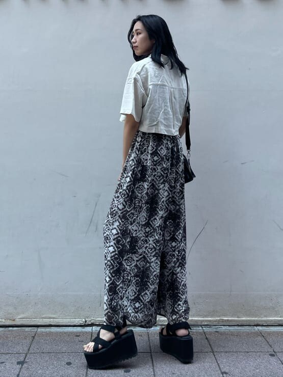 ブラック系のサンダル、その他のスラックスを着用したレディースの夏コーディネートの2枚目の写真