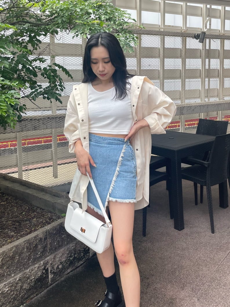 ホワイト系のシャツ/ブラウス、ホワイト系のTシャツ/カットソー、ブルー系のデニムスカートを着用したレディースの夏コーディネートの3枚目の写真