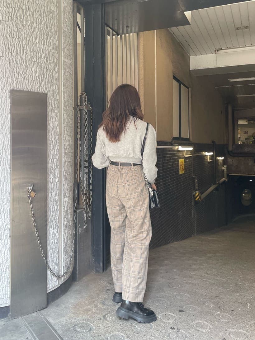 ブラック系のブーツ、その他のその他パンツ、ブラック系のハンドバッグを着用したレディースの秋コーディネートの2枚目の写真