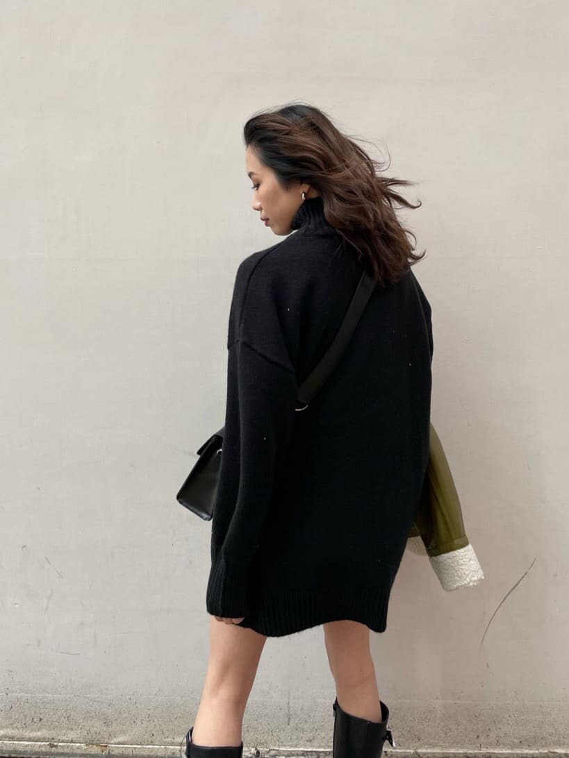 グリーン系のブルゾン、ブラック系のショルダーバッグ、ブラック系のワンピースを着用したレディースの冬コーディネートの5枚目の写真
