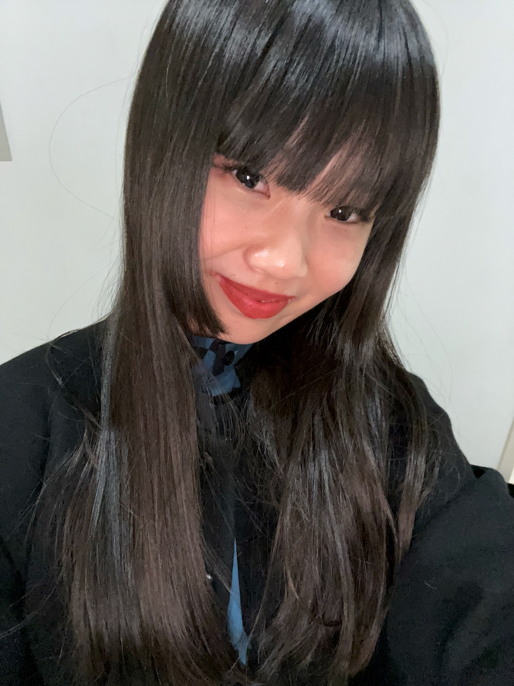 ブラック系のジャケット/アウター、ブルー系のシャツ/ブラウス、ブラック系のスカートを着用したレディースの春コーディネートの2枚目の写真