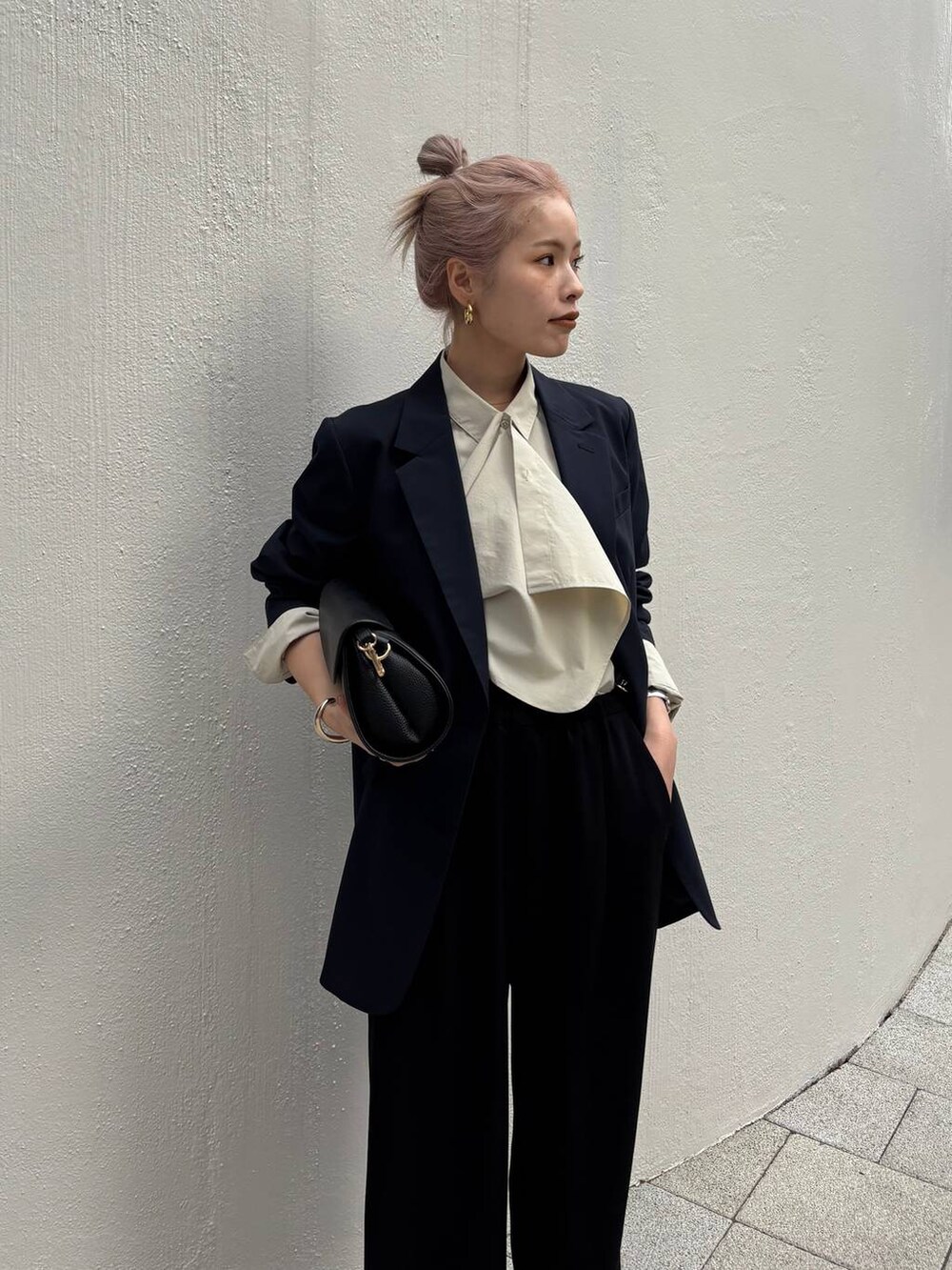 ブラック系のショルダーバッグ、ブラック系のスラックス、ブルー系のテーラードジャケットを着用したレディースの冬コーディネートの4枚目の写真