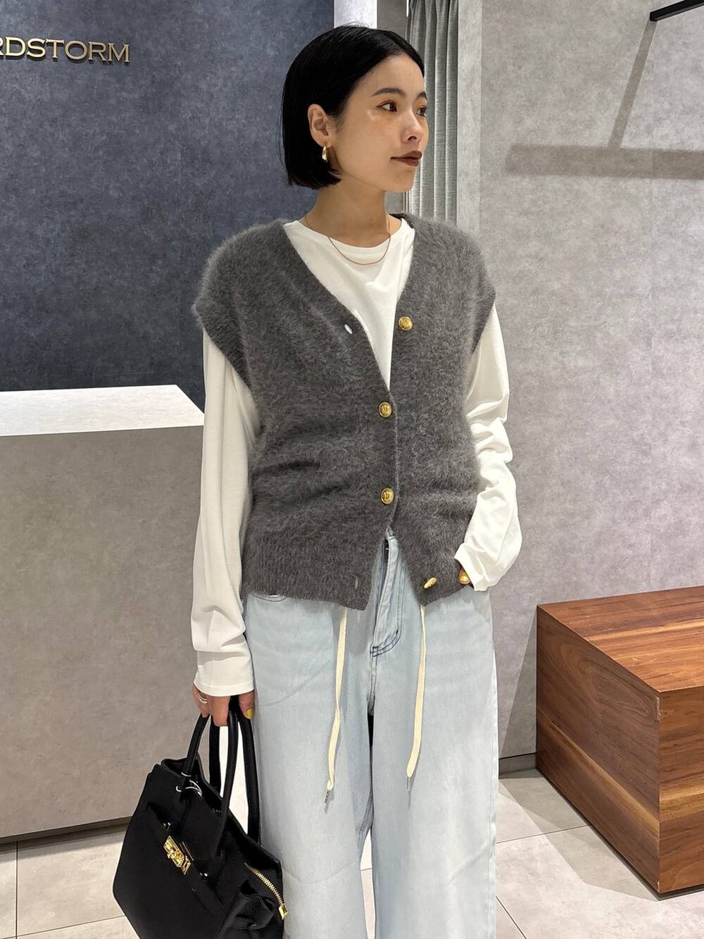 ブラック系のショルダーバッグ、ブルー系のデニムパンツ、ホワイト系のTシャツ/カットソーを着用したレディースの夏コーディネートの6枚目の写真