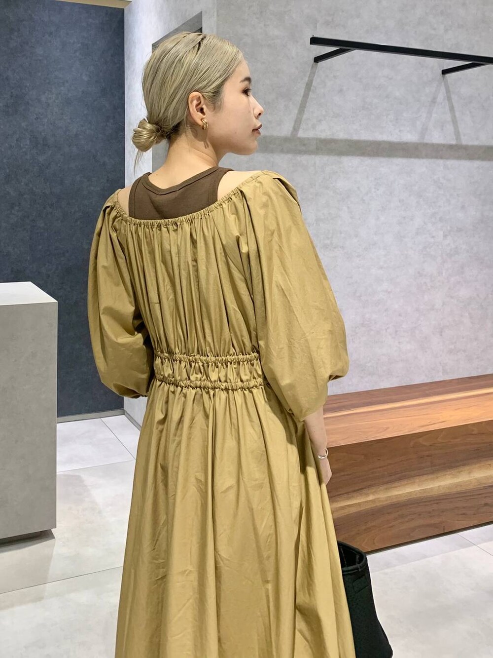 ブラック系のトートバッグ、ブラック系のパンプス、ブラウン系のタンクトップを着用したレディースの夏コーディネートの3枚目の写真