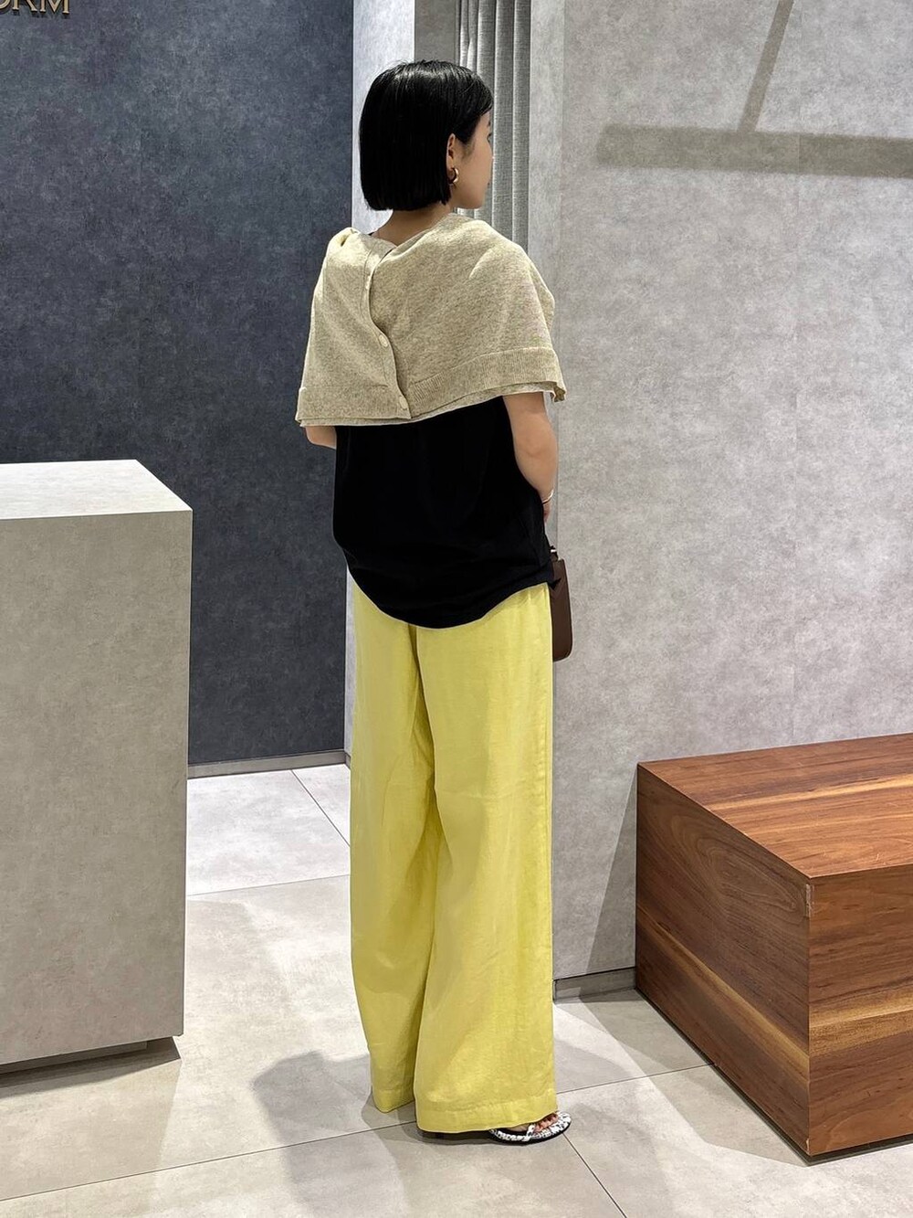 ブラウン系のハンドバッグ、その他のサンダル、イエロー系のその他パンツを着用したレディースの春コーディネートの2枚目の写真