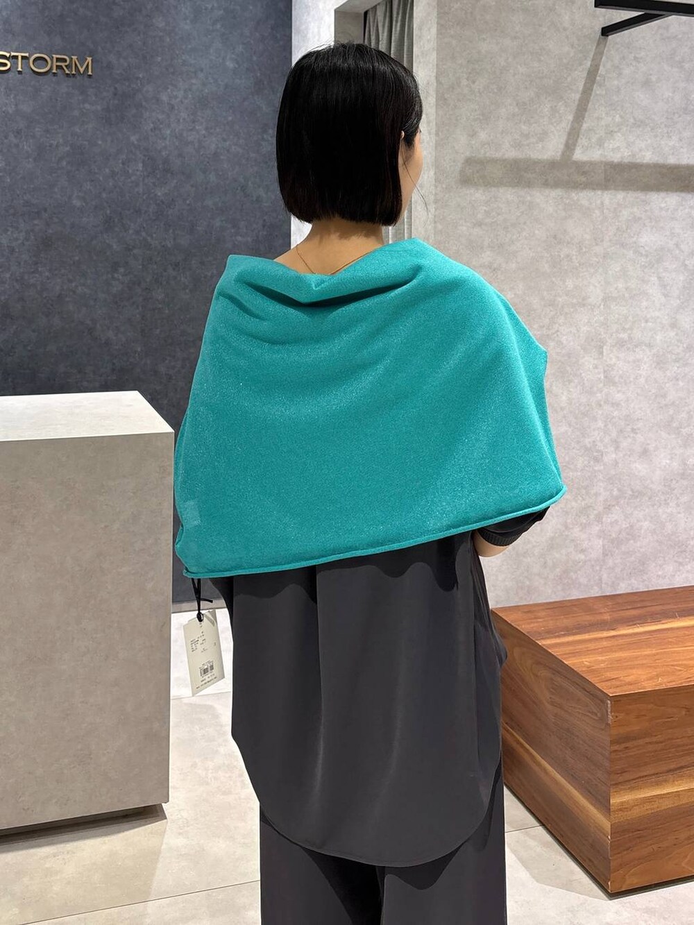 グレー系のシャツ/ブラウス、グレー系のスラックス、グリーン系のニット/セーターを着用したレディースの夏コーディネートの8枚目の写真