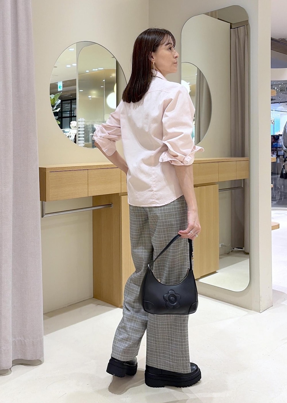 ピンク系のシャツ/ブラウス、グレー系のその他パンツ、ブラック系のブーツを着用したレディースの秋コーディネートの3枚目の写真