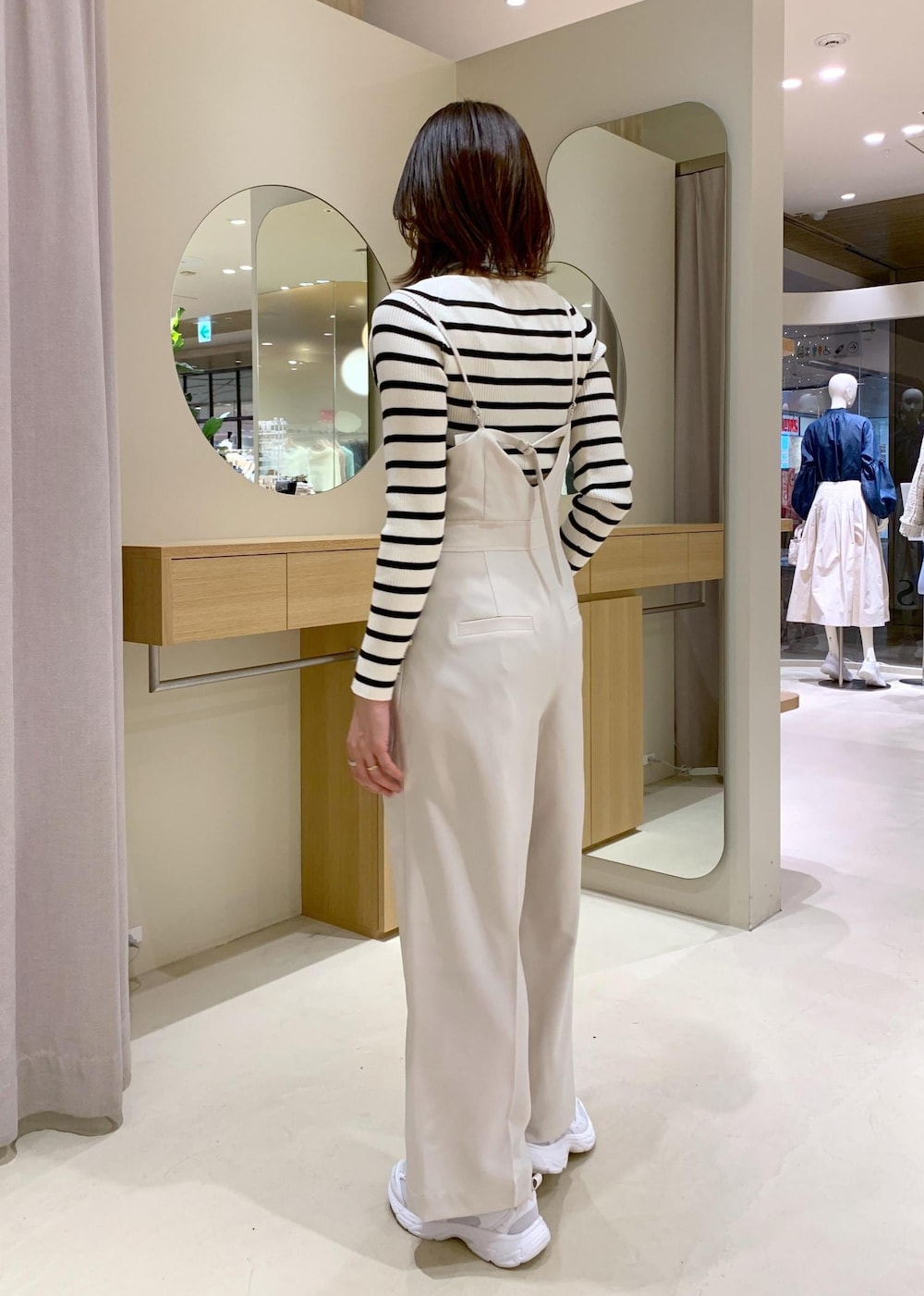 グレー系のショルダーバッグ、ホワイト系のニット/セーター、ブルー系のテーラードジャケットを着用したレディースの冬コーディネートの8枚目の写真