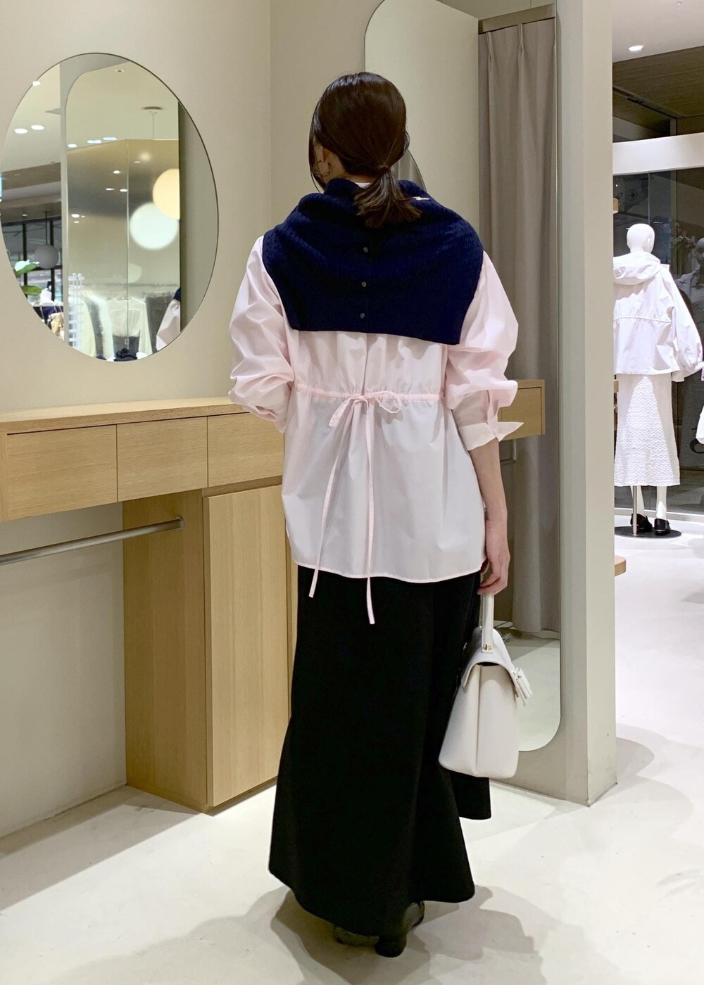 ブラック系のローファー、ホワイト系のハンドバッグ、ピンク系のシャツ/ブラウスを着用したレディースの春コーディネートの4枚目の写真