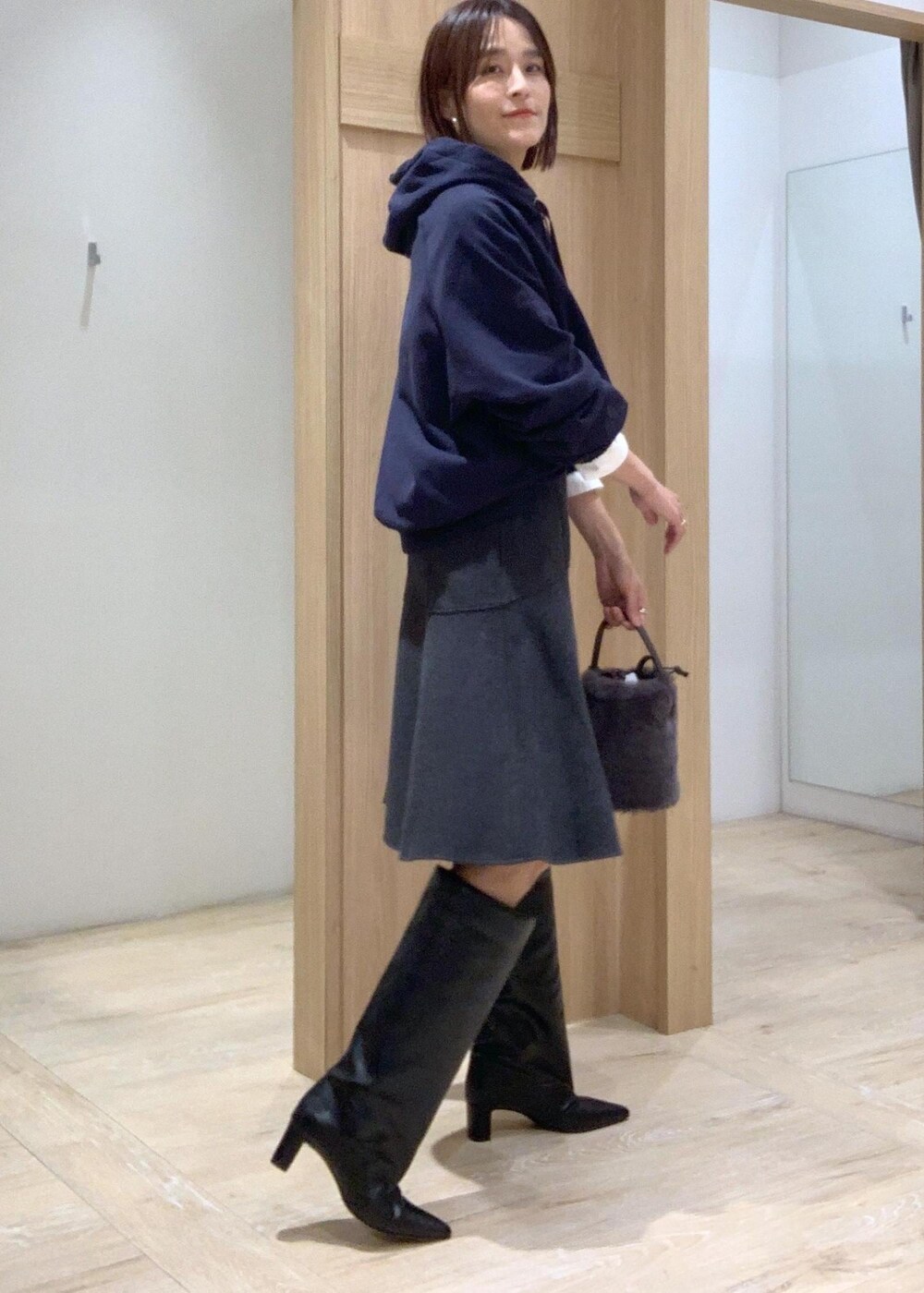 ブラック系のブーツ、グレー系のショルダーバッグ、ホワイト系のシャツ/ブラウスを着用したレディースの秋コーディネートの3枚目の写真