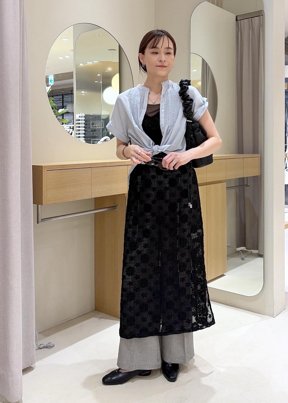 グレー系のその他パンツ、ブラック系のパンプス、ブラック系のショルダーバッグを着用したレディースの春コーディネートの5枚目の写真