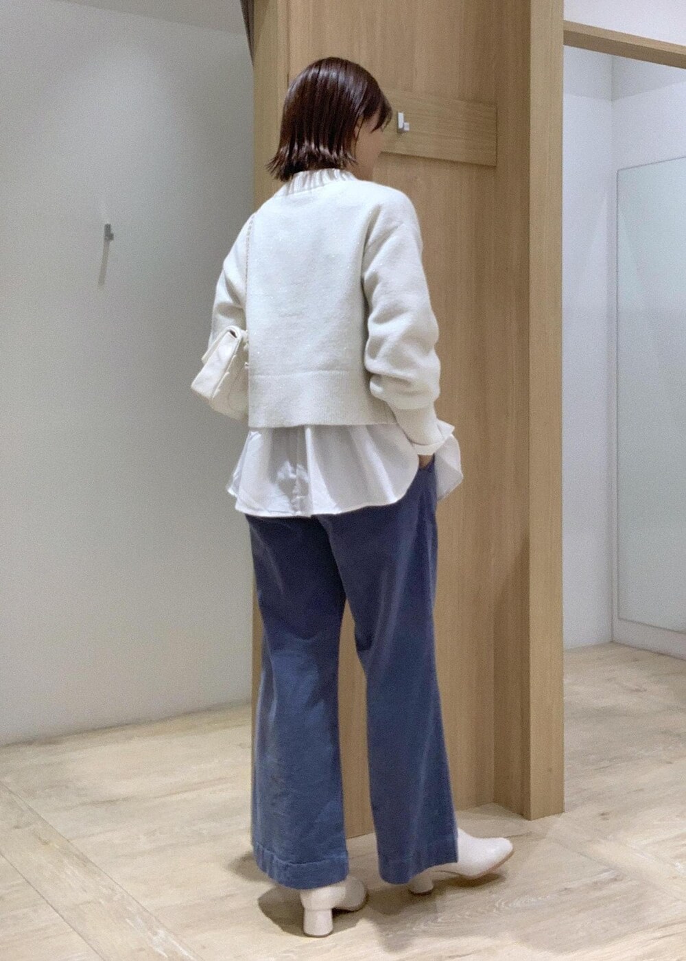 ホワイト系のショルダーバッグ、ホワイト系のカーディガン/ボレロ、ホワイト系のブーツを着用したレディースの秋コーディネートの4枚目の写真