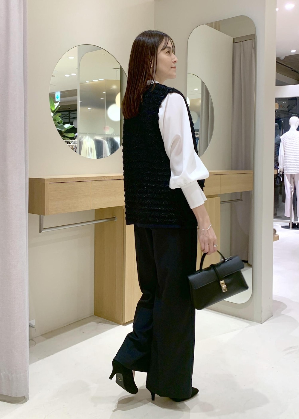 ブラック系のショルダーバッグ、ブルー系のその他パンツ、ホワイト系のシャツ/ブラウスを着用したレディースの冬コーディネートの4枚目の写真