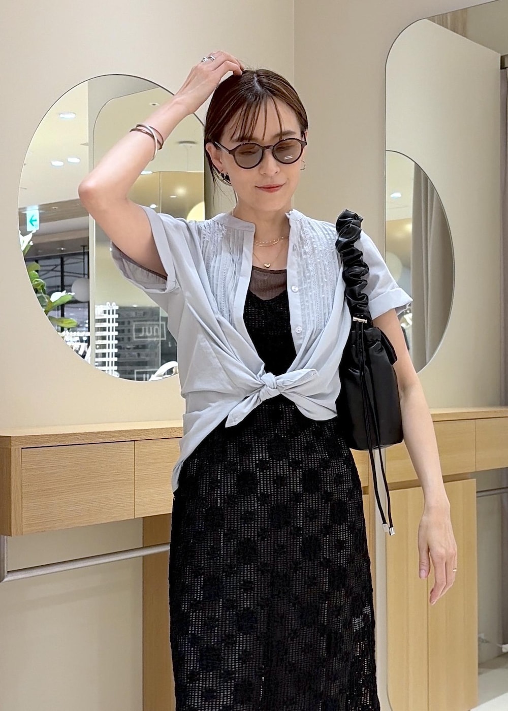 グレー系のその他パンツ、ブラック系のパンプス、ブラック系のショルダーバッグを着用したレディースの春コーディネートの6枚目の写真