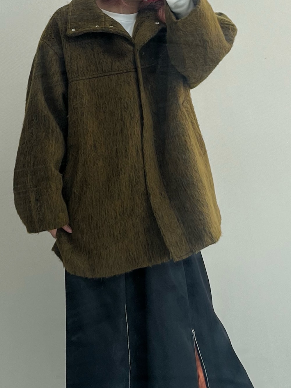 ブラック系のブーツ、ブラック系のスカート、イエロー系のジャケット/アウターを着用したレディースの秋コーディネートの6枚目の写真