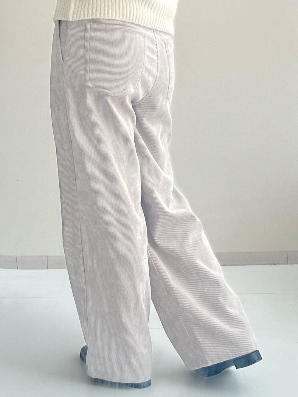 ブラック系のブーツ、ホワイト系のニット/セーター、ホワイト系のその他パンツを着用したレディースの秋コーディネートの3枚目の写真